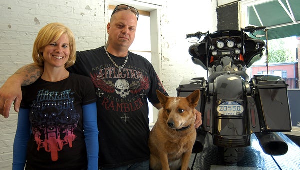 Rob and Jackie Satek stand next to one of their motorcycles with their dog at new Niles business Red Star Gas & Welding Supply. They opened May 1 at 218 N. Front St. Leader photo/CRAIG HAUPERT 