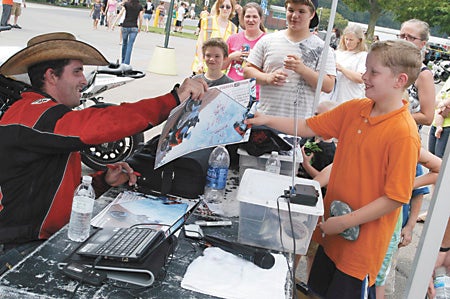 Josh "The Cowboy" Borne, No. 9 professional street bike freestyler in the world, signs autographs Saturday at the Ride for the Homeless at Southwestern Michigan College.