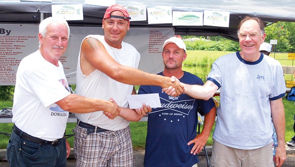 First place for crappie went to Jason Keen and Tobin Thomas. Their first place check is being presented by Millpond Improvement Association President Don Wolford, left, and Dowagiac Mayor Don Lyons, right. (Leader photo/SCOTT NOVAK)