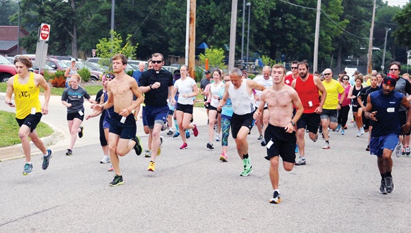 And they are off and running in the first Log Cabin 5K Run in Cassopolis Saturday. (Leader photo/SCOTT NOVAK)