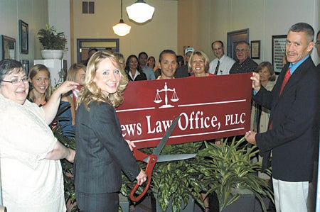 Sarah Mathews cuts the ribbon on her new law office July 2 at 218 S. Front St. with her husband, Southwestern Michigan College President Dr. David Mathews, and mother, Mary Wilkinson. She was co-valedictorian of Dowagiac’s Class of 2000.