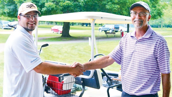 Niles City Golf champion Monty Ort, left, is congratulated by runner-up Doug Freeman after he captured his first Niles City Golf championship at Plym Park Sunday afternoon. (Leader photo/KELLY SWEENEY)