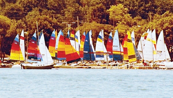 Pictured is the Catamaran Regattas that the Diamond Lake Yacht Club sponsored in the 1980s. The Yacht Club is celebrating its 75th anniversary this year. Below is an old postcard from 1940 that depics the Yacht Club and Marine Hospital. (Leader photo/Provided)