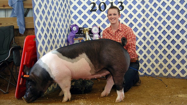 Ashley Rogers, of Niles, poses with her Reserve Grand Champion Market Hog at the Cass County Fair Tuesday. Jeremiah Hartsell had the Grand Champion Market Hog. Leader photo/CRAIG HAUPERT 