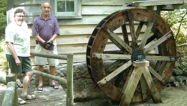 Jim Taylor and Jan Ferris stand next to the new water wheel at Fernwood. Leader photo/CRAIG HAUPERT 