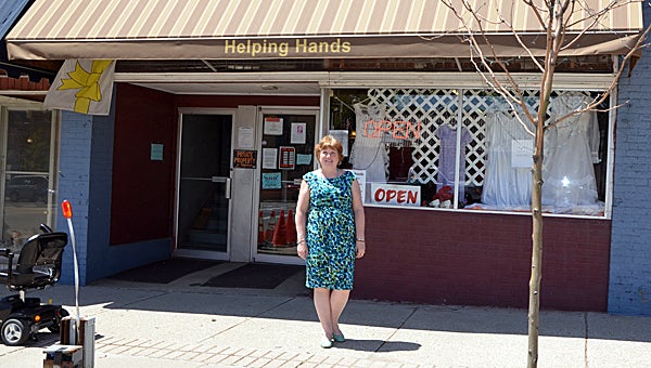 Helping Hands of Cass County Director Mary Tompi shows off the new awning, which was put up in April. (Leader Photo/SCOTT NOVAK)