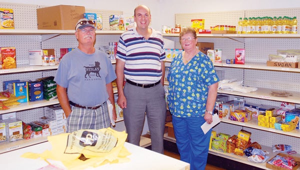 Stan Mason, Edwardsburg Presbyterian Church Pastor Scott Scheel and Norma Wesoloski are concern that because of increased use this summer by families at the food pantry, it could run short during their normal busy months. (Leader photo/SCOTT NOVAK)