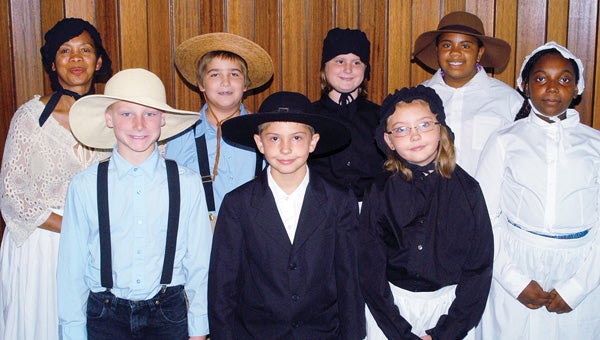 Cassopolis teacher Felomina Patton at Dowagiac Elks Lodge 889 Aug. 15 with seven of 41 Cass County Underground Railroad Wax Museum re-creators: (back) Otto Reick IV, Savage McKee and Ymani Stallworth (a descendant of Harrison Ash); and (front) Todd Bussey, Aidan Ward, Addison Ward (Bogue descendants) and Dynisha Hackworth.  