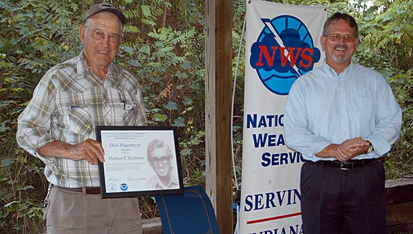Herb Teichman with Jeff Logsdon, meteorologist in charge for the National Weather Service in Syracuse, Ind., who Tuesday afternoon presented the Dick Hagemeyer Award for 45 years of service as a volunteer Cooperative Weather Observer (COOP) in Eau Claire.