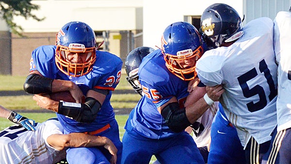 Edwardsburg’s Dylan Hulett breaks through the line with a block from Tyler Lutz (55) during Thursday’s win over Otsego. (Leader photo/KELLY SWEENEY)