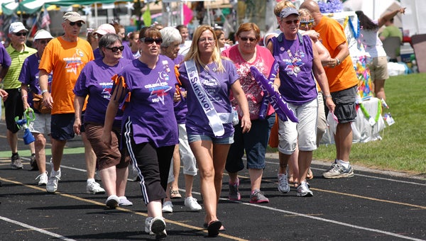 Walkers participate in the opening lap of this year's Niles-Buchanan Relay for Life. Leader photo/CRAIG HAUPERT