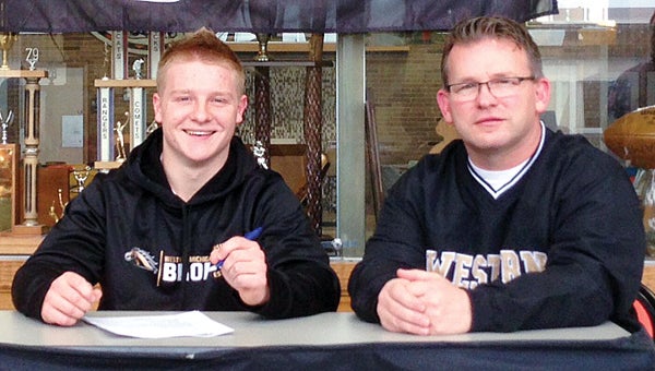 Brett Scanlon, left, is seen here signing his national letter of intent to play football at Western Michigan. He is seen here with father John Scanlon. (Leader photo/File)