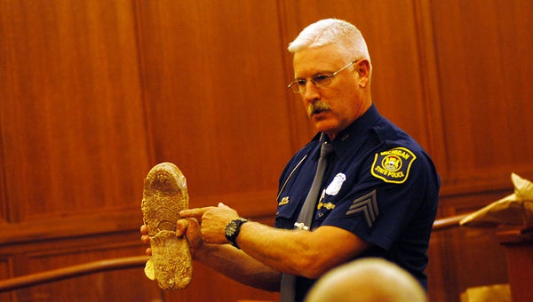 Michigan State Police Sgt. Michael McCarthy shows jurors a molding made from a footprint found in the snow outside the Tarwacki’s home after the February 2010 double homicide. Leader photo/CRAIG HAUPERT