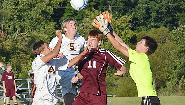 Brandywine’s Blake Learner (5) and Zach Schmidt (20) attempt to get a ball past the Buchanan keeper Thursday afternoon in the Bobcats’ 7-1 loss to the Bucks. (Leader photo/KELLY SWEENEY)