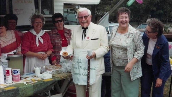 Kentucky Fried Chicken founder Colonel Harland Sanders was the grand marshall of the Apple Festival parade in 1976. He is pictured here wearing a Niles Business and Professional Women’s Club apron with, from left: Jan Gano, Marge Bachman, Joan Clark, Noreen Freeze, Donna Ochenryder and Olove Colcord. Photo courtesy of Donna Ochenryder