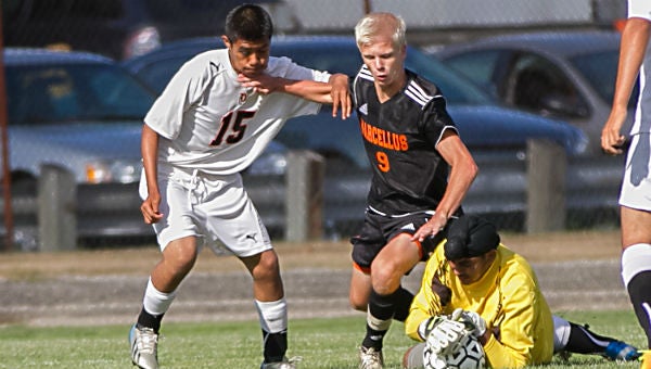 Dowagiac’s Leo Brito (15) keeps Marcellus’ Niels Verleum away from Dowagiac keeper Harpeet Singh. Verleum had a pair of goals in the Wildcats’ 6-1 win over the Chieftains. (Leader photo/SCOTT ROSE)