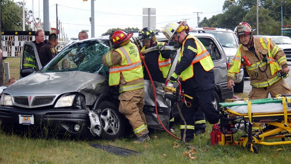 Police work to free a Niles woman trapped in a van after a two-vehicle accident Thursday afternoon at the intersection of Fulkerson and South 11th Street in Niles Township. Leader photo/CRAIG HAUPERT