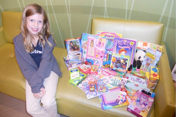 Layla True with the gifts she picked out for children in the pediatric ward at Memorial Hospital on her 8th birthday. Provided photo