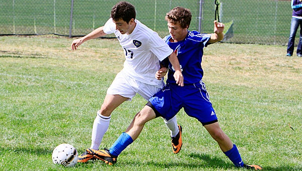 Niles’ Adria Gonzalez, left, battles with Edwardsburg’s Zac Griffith for a ball during Saturday’s match. The Vikings defeated the Eddies 6-1. (Leader photo/AMELIO RODRIGUEZ)