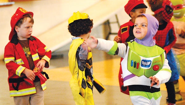 Riley Barger, dressed as Buzz Lightyear, waives to parents watching the annual Halloween Parade at St. Mary’s Catholic School in Niles Thursday. Leader photo/CRAIG HAUPERT