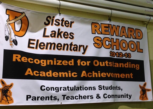 A banner congratulating students, parents teachers and the Sister Lakes community for their success in becoming a reward school hangs in Sister Lakes Elementary to remind students of their achievement throughout the school year. Provided Photo