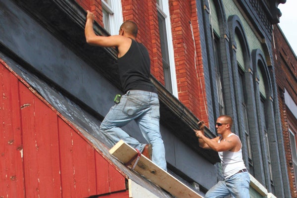 Employees of Scott Wade Construction work on the front facade of  Shabby Bou-Chic, formerly Hope’s Door, in downtown Dowagiac.  The business recently came under new ownership.  Owner Toysa True features the works of local artists in what she calls “the not too shabby thrift store.”  Owners of downtown buildings will have an opportunity this fiscal year to apply to the Downtown Development Authority for an incentive of up to $2,000 to help them renovate their storefronts.  Photo Courtesy of Vickie Phillipson, Chamber of Commerce & DDA Program Director