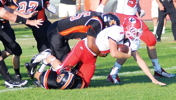 Dowagiac’s Carl Grant and Chase Camp, seen here tackling Vicksburg’s quarterback in the season opener, were both named first team defense on the All-Wolverine Conference West Division football team. (Leader photo/File)