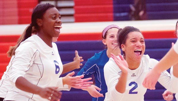 The Cassopolis volleyball team reacts to its thrilling five-set victory over Bridgman in the opening round of the Class C District Tournament Monday night. (Leader photo/JOSEPH WEISER)
