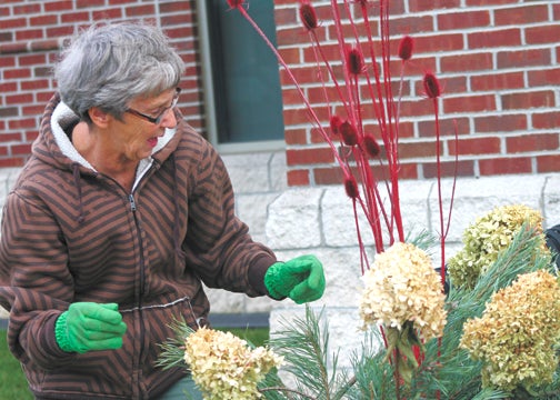 Candy Azevedo, of Dowagiac prepare the downtown area of Dowagiac for winter festivities. Doty and Azevedo are both members of the Town and Country Garden Club, which keeps the downtown area constantly in bloom throughout the year. Leader Photo/AMBROSIA NELDON